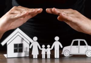 hands protecting a paper house, family, and car