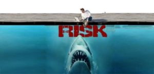 Risk shown with shark and man on beach